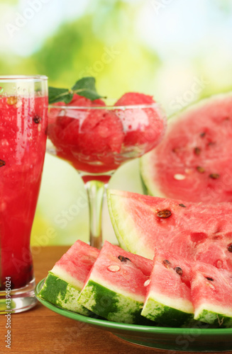 Photo: Refreshing desserts of watermelon on green background close-up Refreshing desserts of watermelon on green background close-up