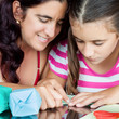 Mother and daughter making playing and making origami