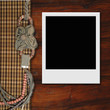 Instant photo frame on wooden background, vintage style