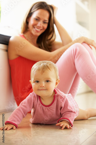 Photo: Mother Sitting With Baby Daughter At Home Mother Sitting With Baby Daughter At Home