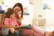 Foto: Mother Sitting With Son Reading Story Indoors Mother Sitting With Son Reading Story Indoors