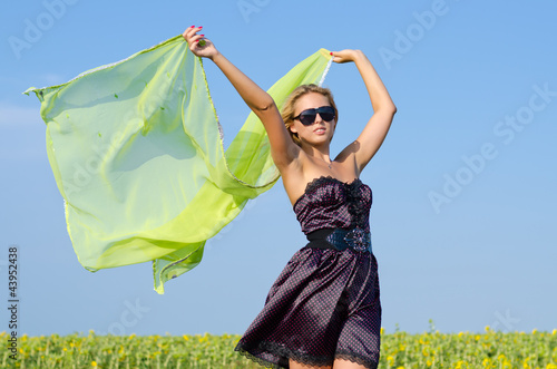 Photo: Woman with green scarf blowing in wind Woman with green scarf blowing in wind