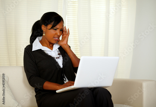 Photo: Pretty woman with headache working up to the limit Pretty woman with headache working up to the limit