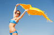 happy woman with yellow sarong on the beach