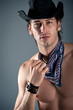 Portrait of confident young cowboy man shirtless.