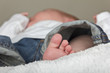baby in Jeans mit Babyfuß barfuß