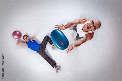 Photo: overhead view of two white men throwing balls overhead view of two white men throwing balls