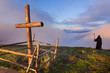 Catholic cross on a mountaintop and death that stands apart