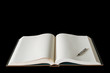 Large open spread book and fountain pen isolated on black