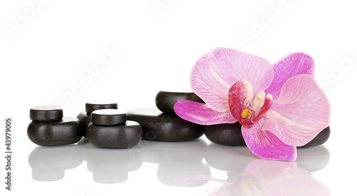 Photo: Spa stones with orchid flower isolated on white Spa stones with orchid flower isolated on white