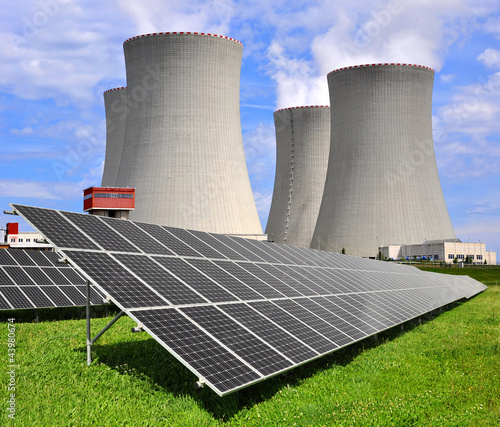Photo: Solar energy panels before a nuclear power plant Solar energy panels before a nuclear power plant
