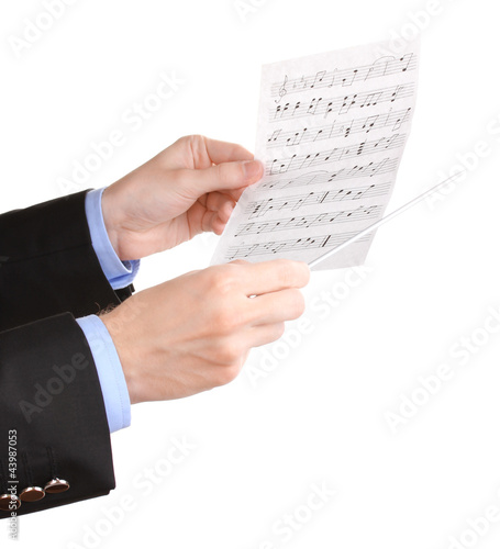 Photo: Music conductor hands with baton and notes isolated on white Music conductor hands with baton and notes isolated on white
