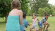 Video: Happy school children playing tug of war in park Happy school children playing tug of war in park