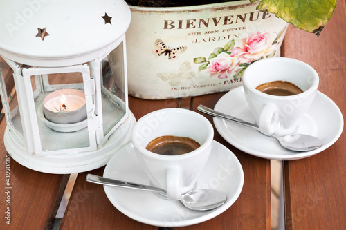Photo: Two cups of espresso coffee cafeteria garden closeup Two cups of espresso coffee cafeteria garden closeup