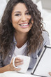 Woman Smiling Drinking Tea or Coffee Using Tablet Computer