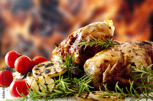 Photo: barbecued chicken legs rosemary tomatoes and patatoes barbecued chicken legs rosemary tomatoes and patatoes