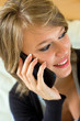 Photo: young pretty blonde woman with mobile at home young pretty blonde woman with mobile at home