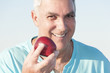 Photo: Mature man holding an apple Mature man holding an apple