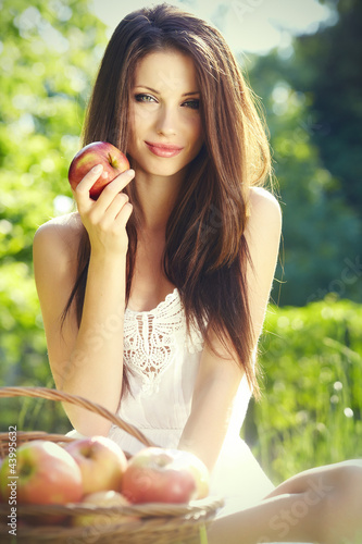 Photo: Apple woman. Very beautiful ethnic model eating red apple in the Apple woman. Very beautiful ethnic model eating red apple in the