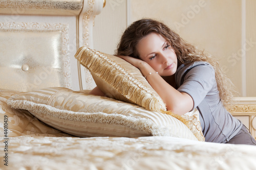 Photo: Beautiful woman in a bedroom Beautiful woman in a bedroom