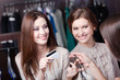 Smiley women pay with credit card for purchases