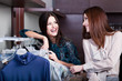 Friends do shopping at the boutique with great choice of clothes