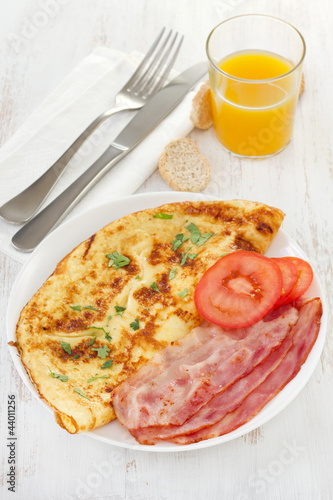 Photo: omelet with bacon and tomato on the plate omelet with bacon and tomato on the plate