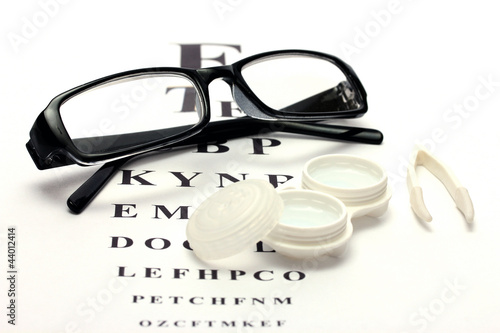 Photo: glasses, contact lenses in containers and tweezers, glasses, contact lenses in containers and tweezers,