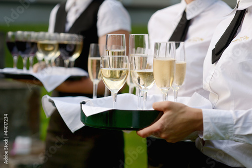 Photo: Waitress with dish of champagne glasses Waitress with dish of champagne glasses
