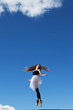 Foto: Ballerina dancing on the roof, clouds behind her Ballerina dancing on the roof, clouds behind her