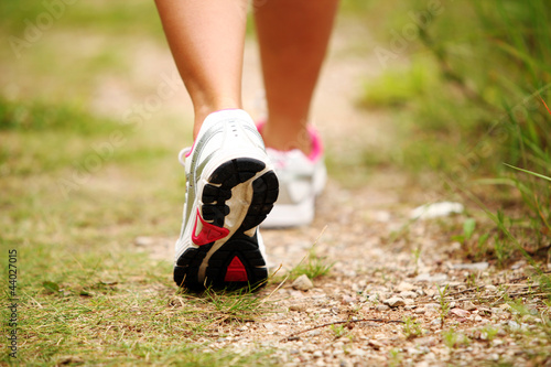Photo: Female legs jogging on a trail Female legs jogging on a trail