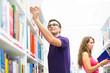 Two college students in library (color toned image; shallow DOF)