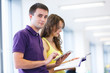 Two college students in library (color toned image; shallow DOF)