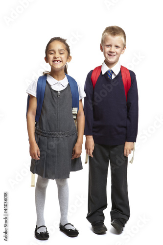 Photo: School boy and girl on white background School boy and girl on white background