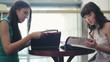 Two female friends reading menu in restaurant, steadicam shot
