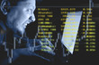 Man working on laptop in the dark