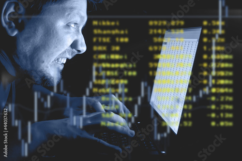 Photo: Man working on laptop in the dark Man working on laptop in the dark