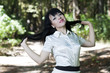 charming young brunette in park