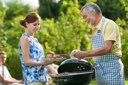 Photo: Family having a barbecue party Family having a barbecue party