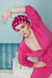 Photo: Portrait of young woman stretching while standing on bed Portrait of young woman stretching while standing on bed