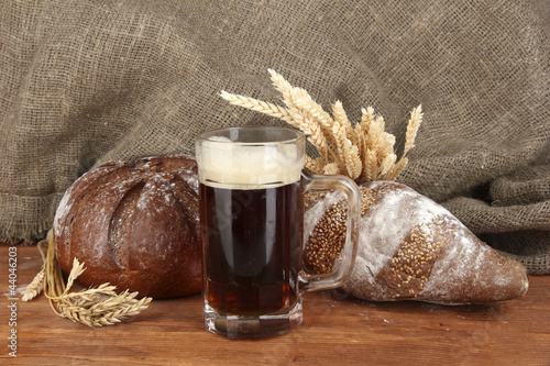 Photo: glass of kvass with bread on canvas background close-up glass of kvass with bread on canvas background close-up
