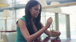 Young beautiful pensive woman drinking cocktail in cafe