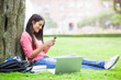 Photo: Hispanic college student texting Hispanic college student texting