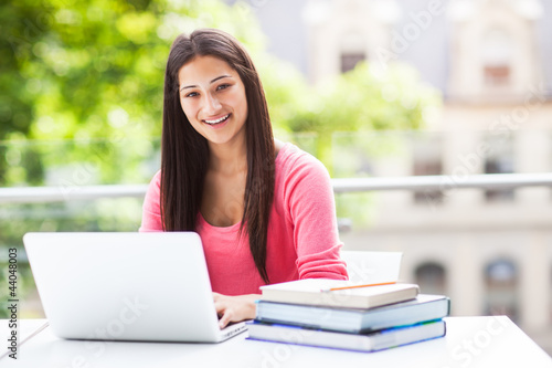 Photo: Hispanic college student with laptop Hispanic college student with laptop