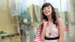 Video: Attractive young woman with shopping bags in the city Attractive young woman with shopping bags in the city