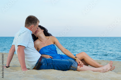 Photo: Loving couple kissing on the beach Loving couple kissing on the beach