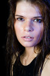 Foto: The wet girl with the spread cosmetics on the black The wet girl with the spread cosmetics on the black