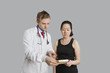Male doctor suggesting medication to female patient