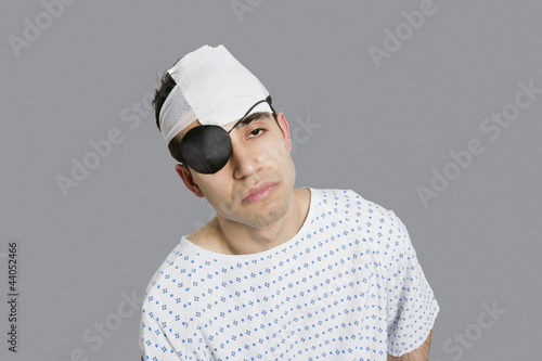 Photo: Male patient wearing an eye patch suffering from head injury Male patient wearing an eye patch suffering from head injury