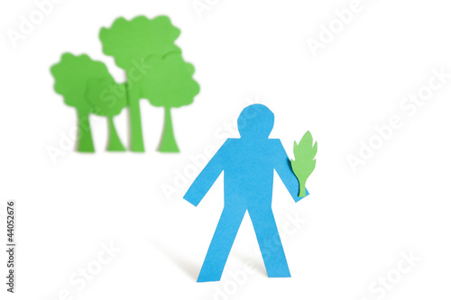 Photo: A blue stick figure holding a leaf representing concept of nature perseverance over white background A blue stick figure holding a leaf representing concept of nature perseverance over white background